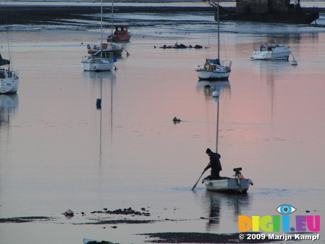 SX02548 Man on boat in Malahide Marina